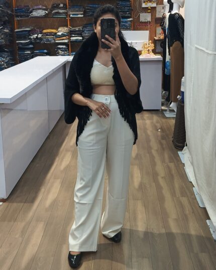 Women cream crop top with white trousers and black fur top