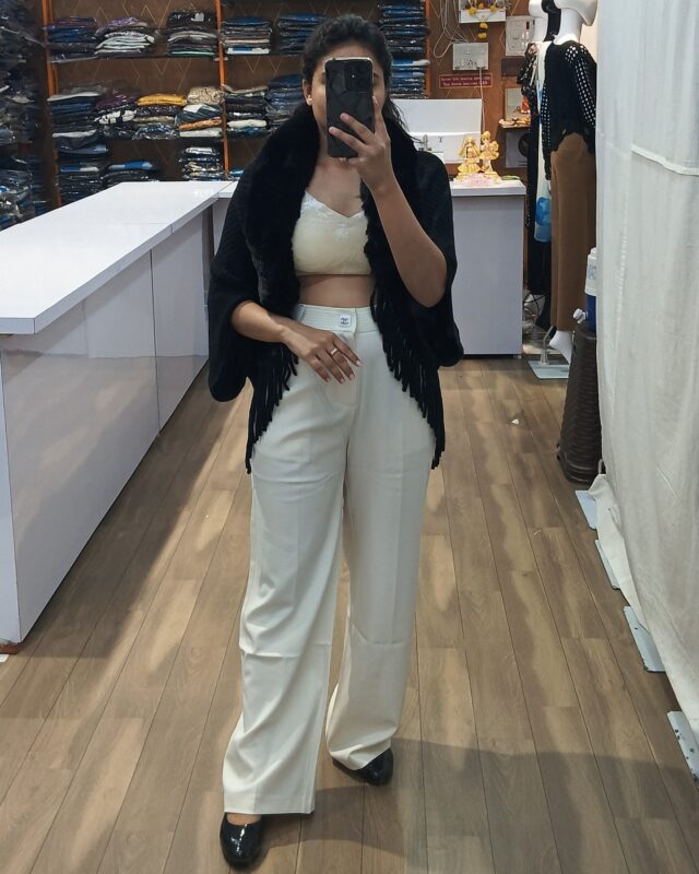 Women cream crop top with white trousers and black fur top